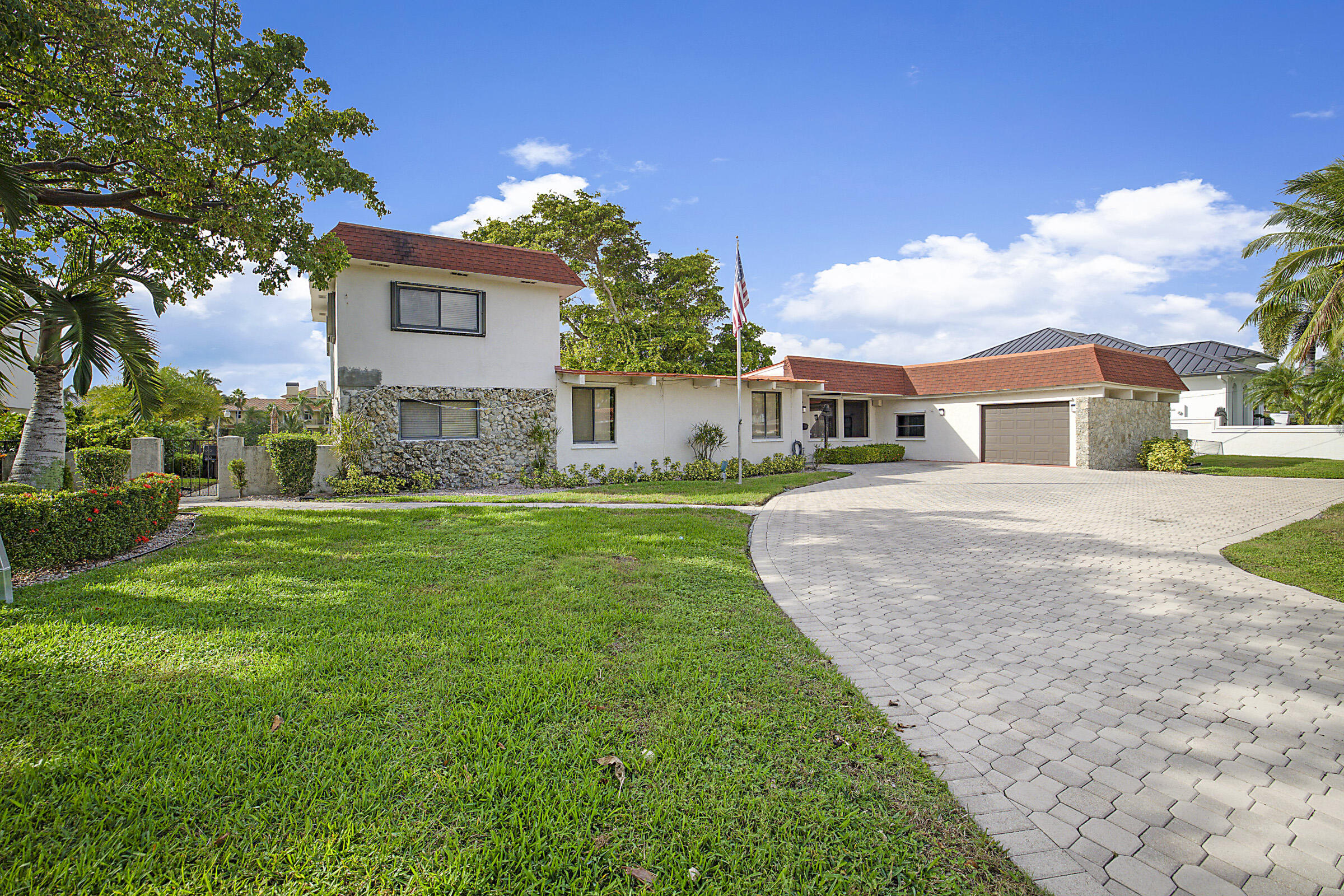 1901 North Riverside Drive Pompano Beach, FL 33062 - Photo 5 of 45 a view of a white house with a big yard and potted plants