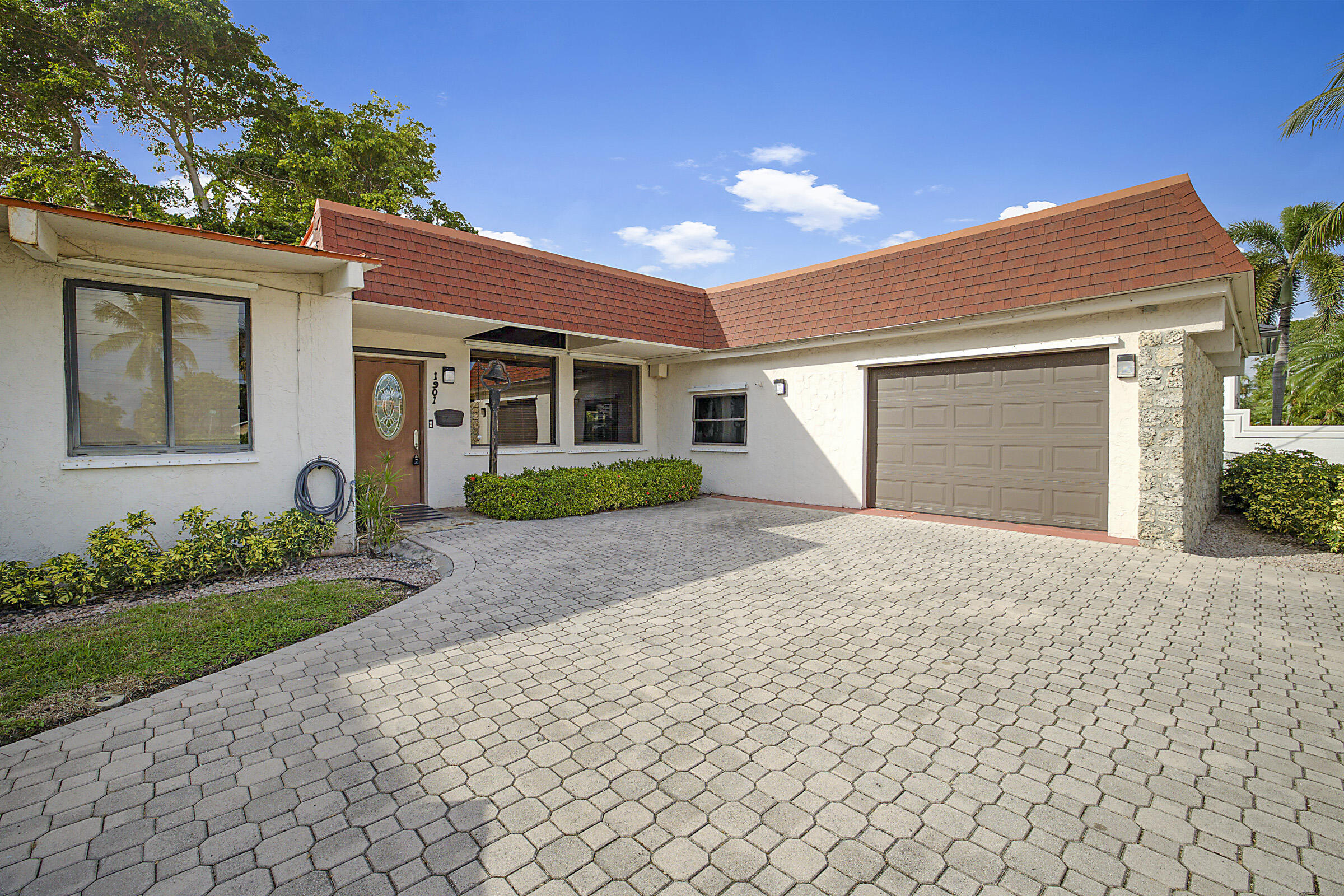 1901 North Riverside Drive Pompano Beach, FL 33062 - Photo 6 of 45 a front view of a house with garden