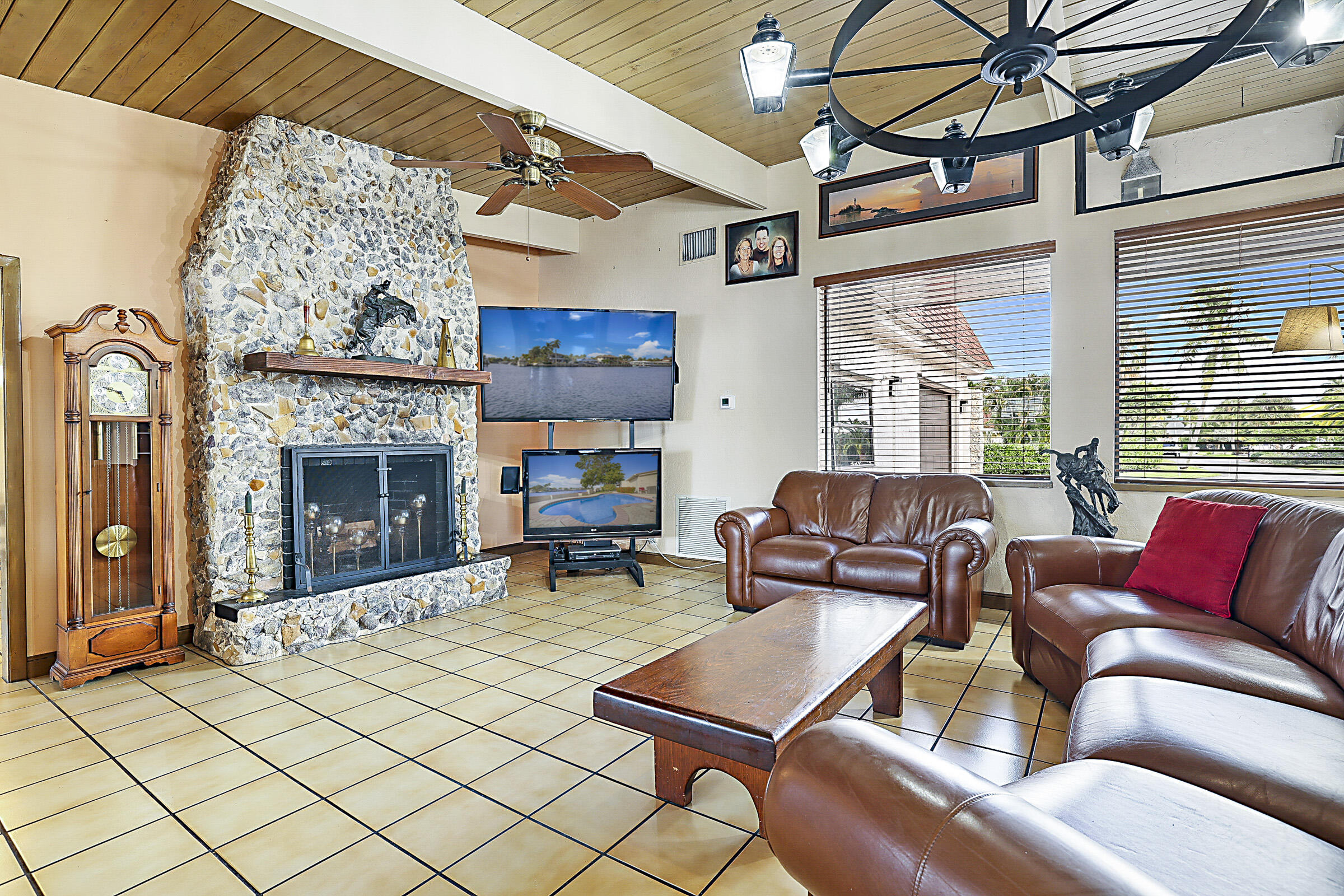 1901 North Riverside Drive Pompano Beach, FL 33062 - Photo 9 of 45 a living room with furniture a fireplace and a flat screen tv
