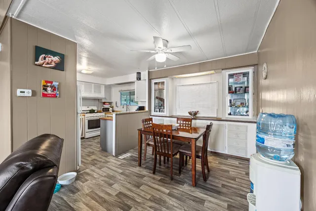 a view of a dining room with furniture and a chandelier