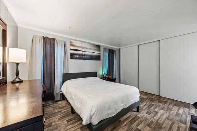 a bedroom with a large bed and a closet