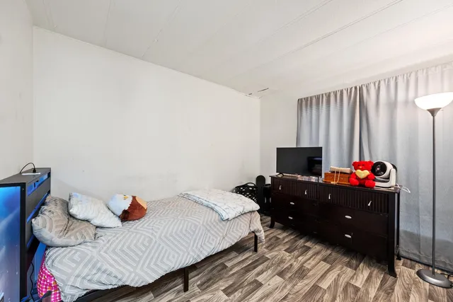 a bedroom with a bed and a flat screen tv