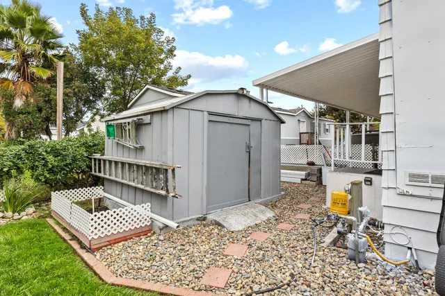 a view of roof deck with chair and wooden fence