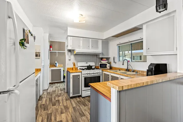a kitchen with a stove a sink and a refrigerator