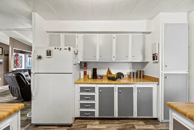 a white refrigerator freezer sitting inside of a kitchen