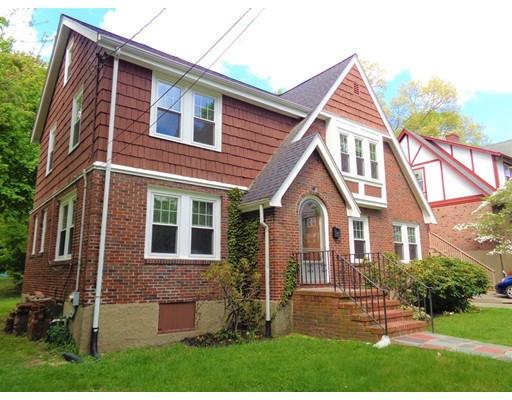 17 Ireland Road Newton, MA 02459 - Photo 21 of 24 a view of a brick house with a yard plants and a large tree
