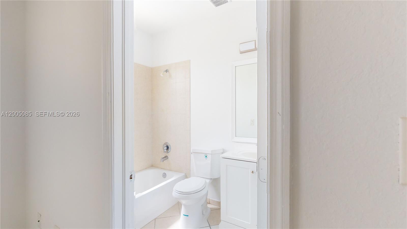 2929 Southeast 2nd Street, Unit 7 Homestead, FL 33033 - Photo 21 of 24 a bathroom with a granite countertop toilet a sink and a bathtub