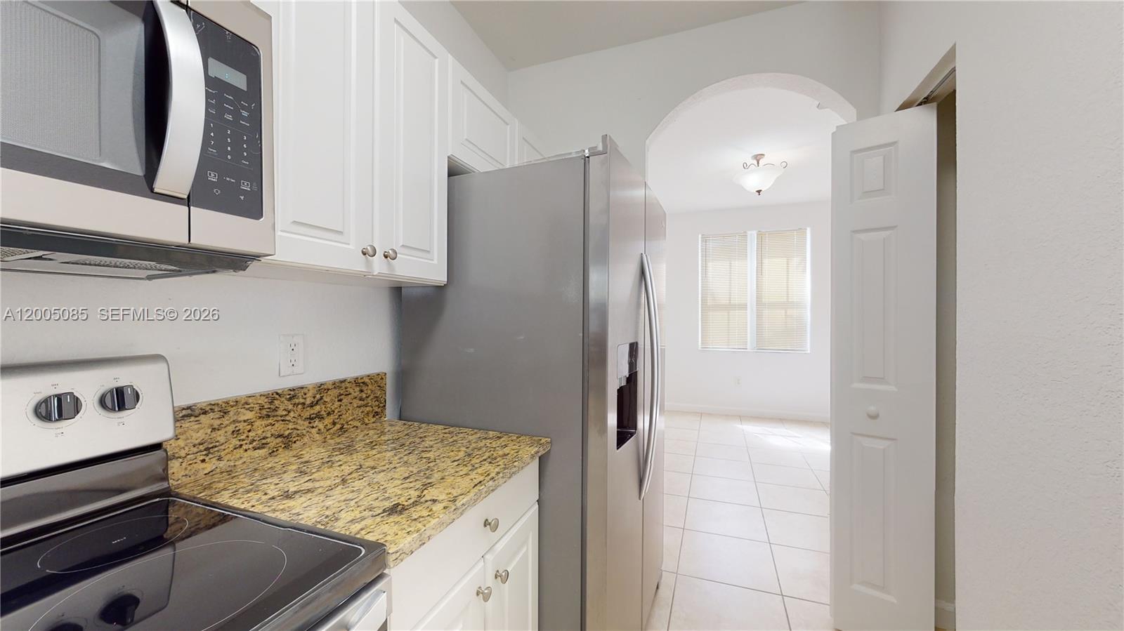 2929 Southeast 2nd Street, Unit 7 Homestead, FL 33033 - Photo 5 of 24 a kitchen with a refrigerator and a stove