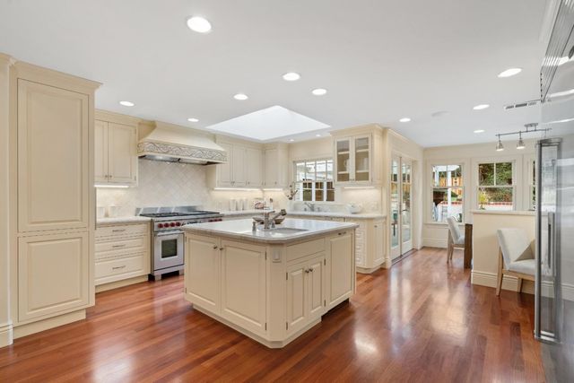a kitchen with stainless steel appliances granite countertop a stove oven and a refrigerator