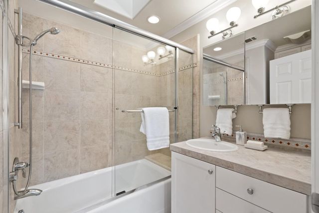 a bathroom with a granite countertop sink a shower and a mirror