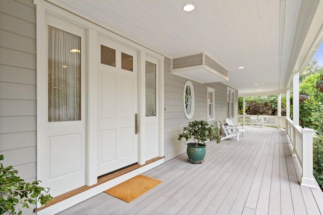 a room with wooden floor and a potted plant