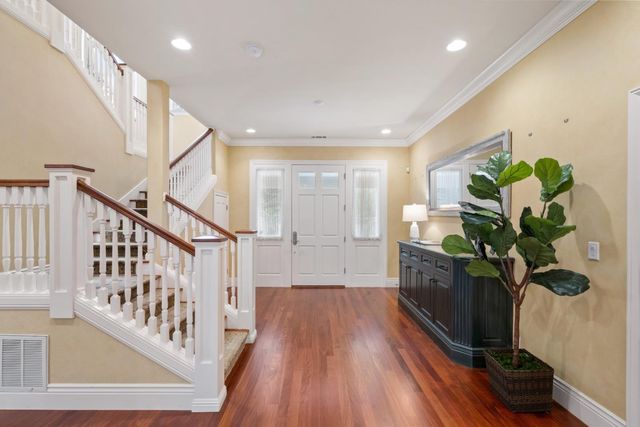 a view of an entryway with wooden floor