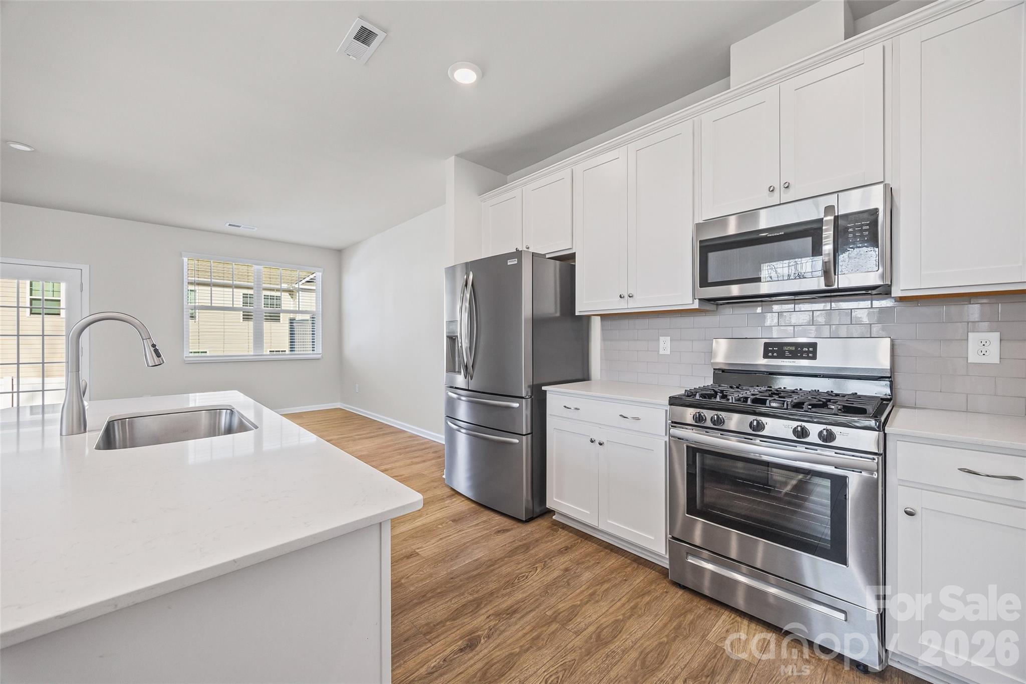 612 Rustic Path Lane Fort Mill, SC 29708 - Photo 13 of 38 a kitchen with stainless steel appliances granite countertop a stove a sink and a refrigerator