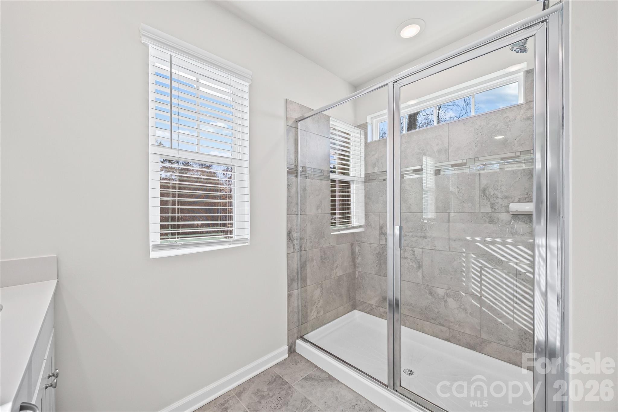 612 Rustic Path Lane Fort Mill, SC 29708 - Photo 18 of 38 a bathroom with a glass shower door