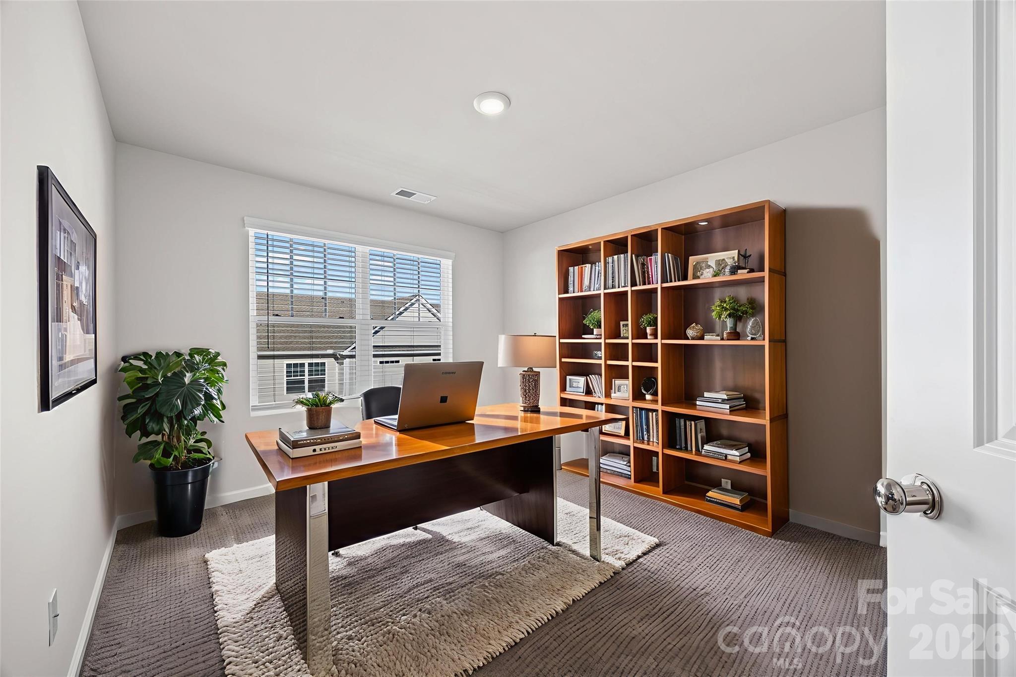 612 Rustic Path Lane Fort Mill, SC 29708 - Photo 5 of 38 a view of a workspace with furniture and bookshelf