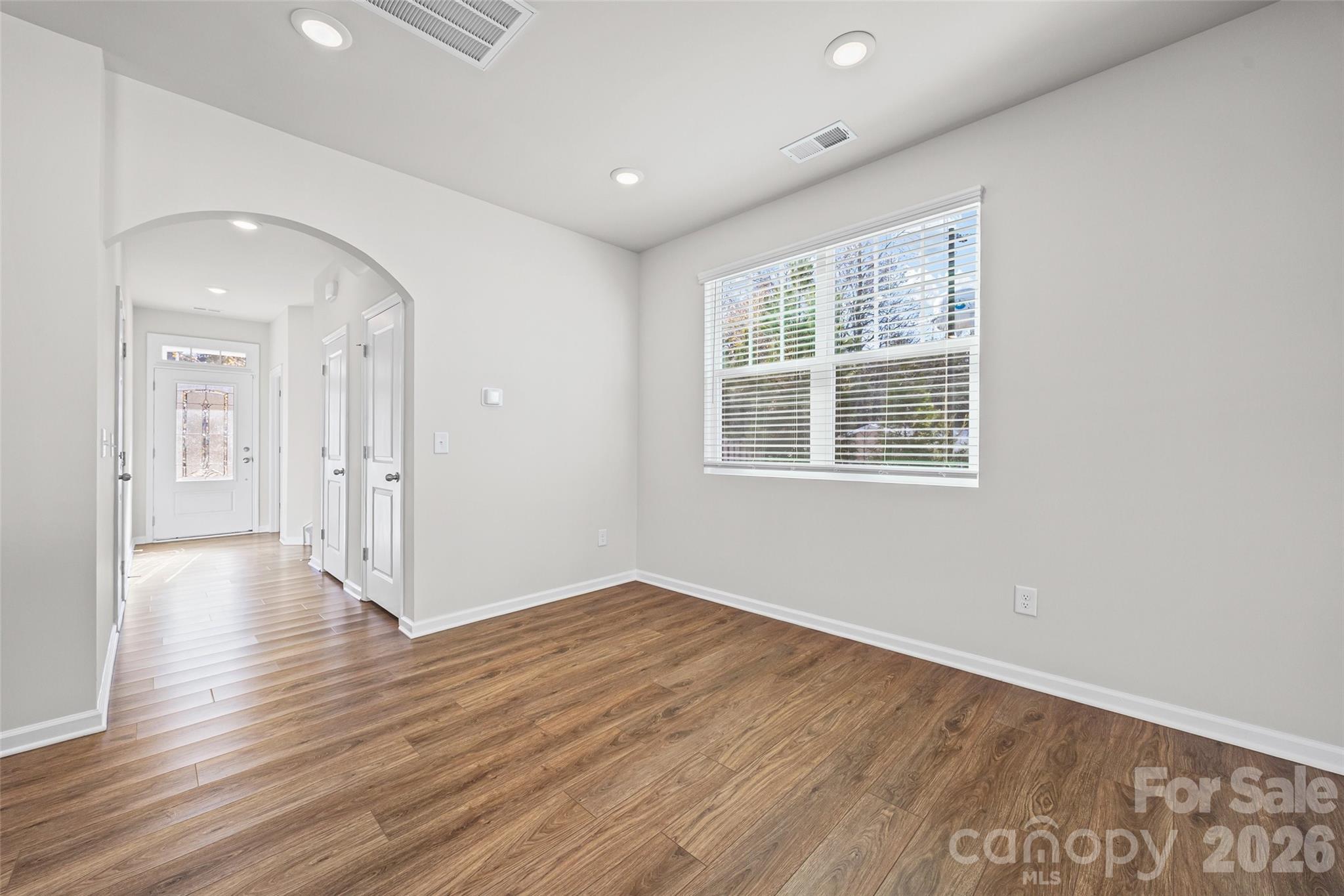 612 Rustic Path Lane Fort Mill, SC 29708 - Photo 10 of 38 a view of an empty room with wooden floor and a window