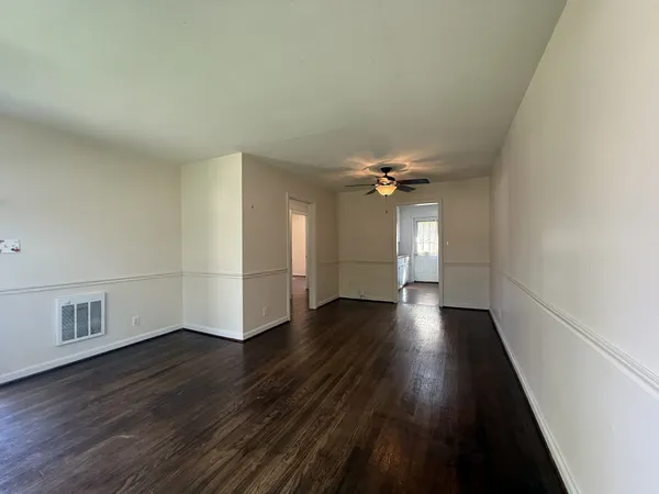 wooden floor in an empty room with a window