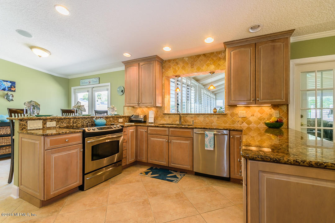 14446 Stacey Road Jacksonville, FL 32250 - Photo 17 of 31 a kitchen with stainless steel appliances granite countertop a stove a sink and a refrigerator