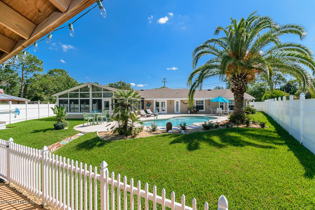 14446 Stacey Road Jacksonville, FL 32250 - Photo 2 of 31 a front view of a house with swimming pool having outdoor seating