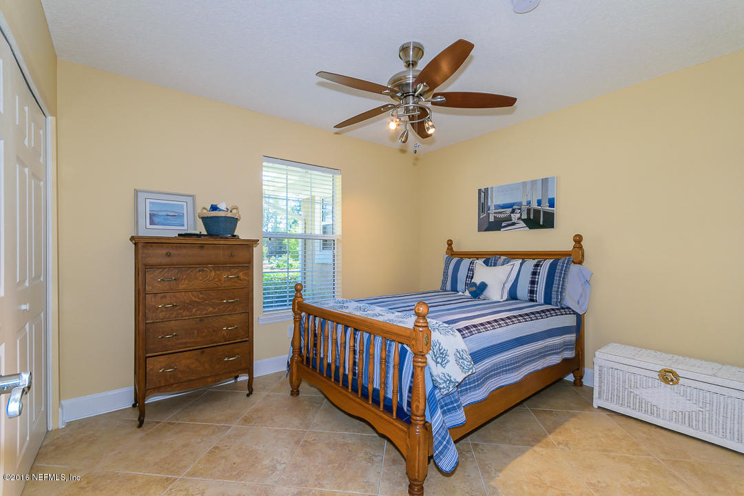 14446 Stacey Road Jacksonville, FL 32250 - Photo 24 of 31 a bedroom with a bed and a dresser