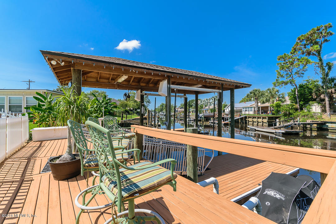 14446 Stacey Road Jacksonville, FL 32250 - Photo 10 of 31 a view of a patio with couches table and chairs and potted plants