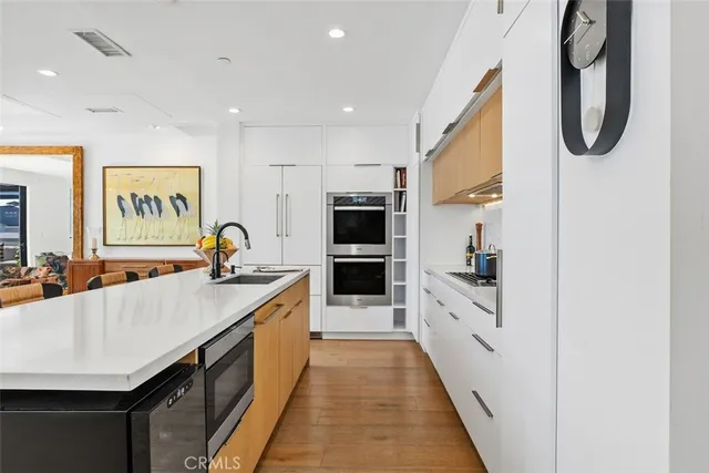 a kitchen with a dining table chairs and a refrigerator