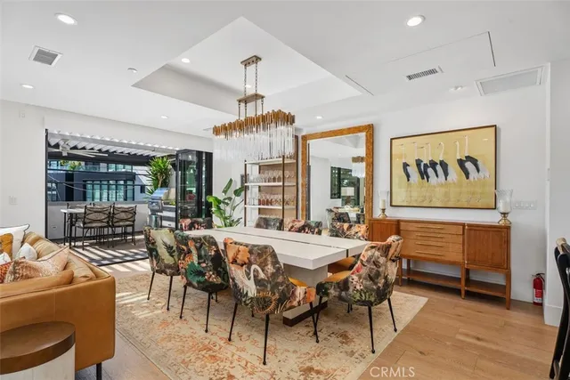 a view of a dining room with furniture large windows and wooden floor