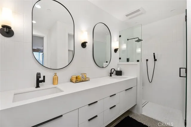 a spacious bedroom with a bed a couch and a flat screen tv