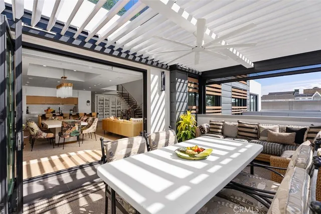 a view of a patio with table and chairs and potted plants