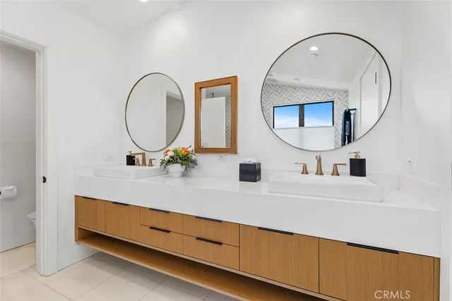 a bathroom with a tub sink and mirror