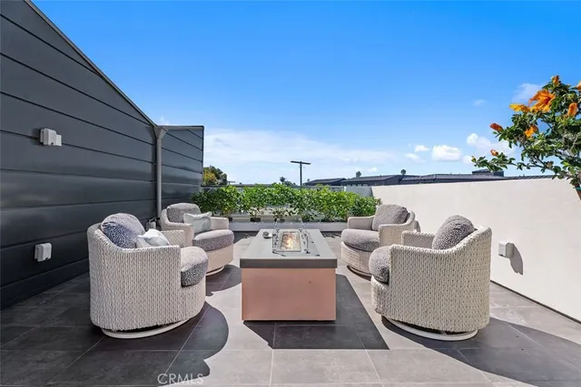 a view of a patio with couches chairs and a fire pit