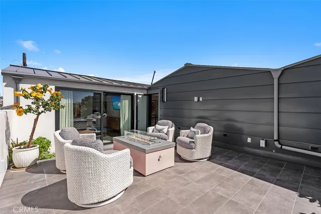a view of a patio with couches and potted plants