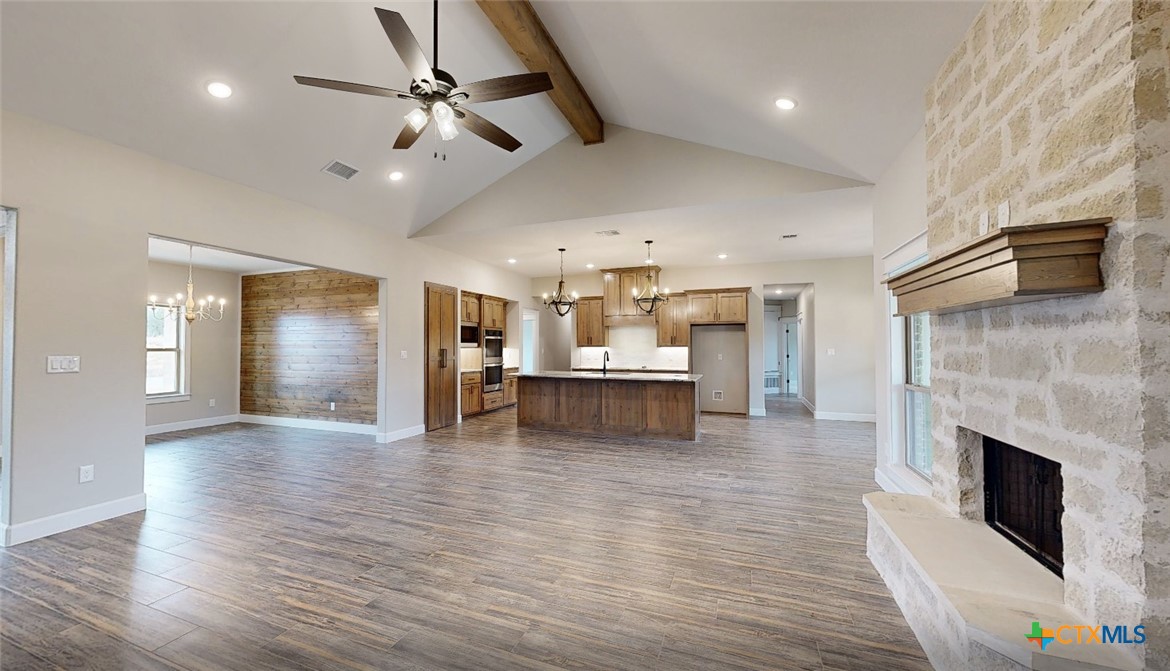 4219 Cool Basin Road Kempner, TX 76539 - Photo 8 of 25 a view of an empty room with kitchen and fireplace