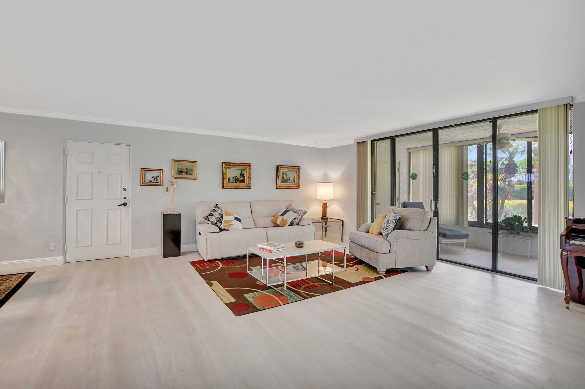7194 Promenade Drive, Unit 102 Boca Raton, FL 33433 - Photo 6 of 56 a living room with furniture and a large window