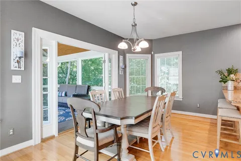 a view of a dining room with furniture wooden floor and chandelier