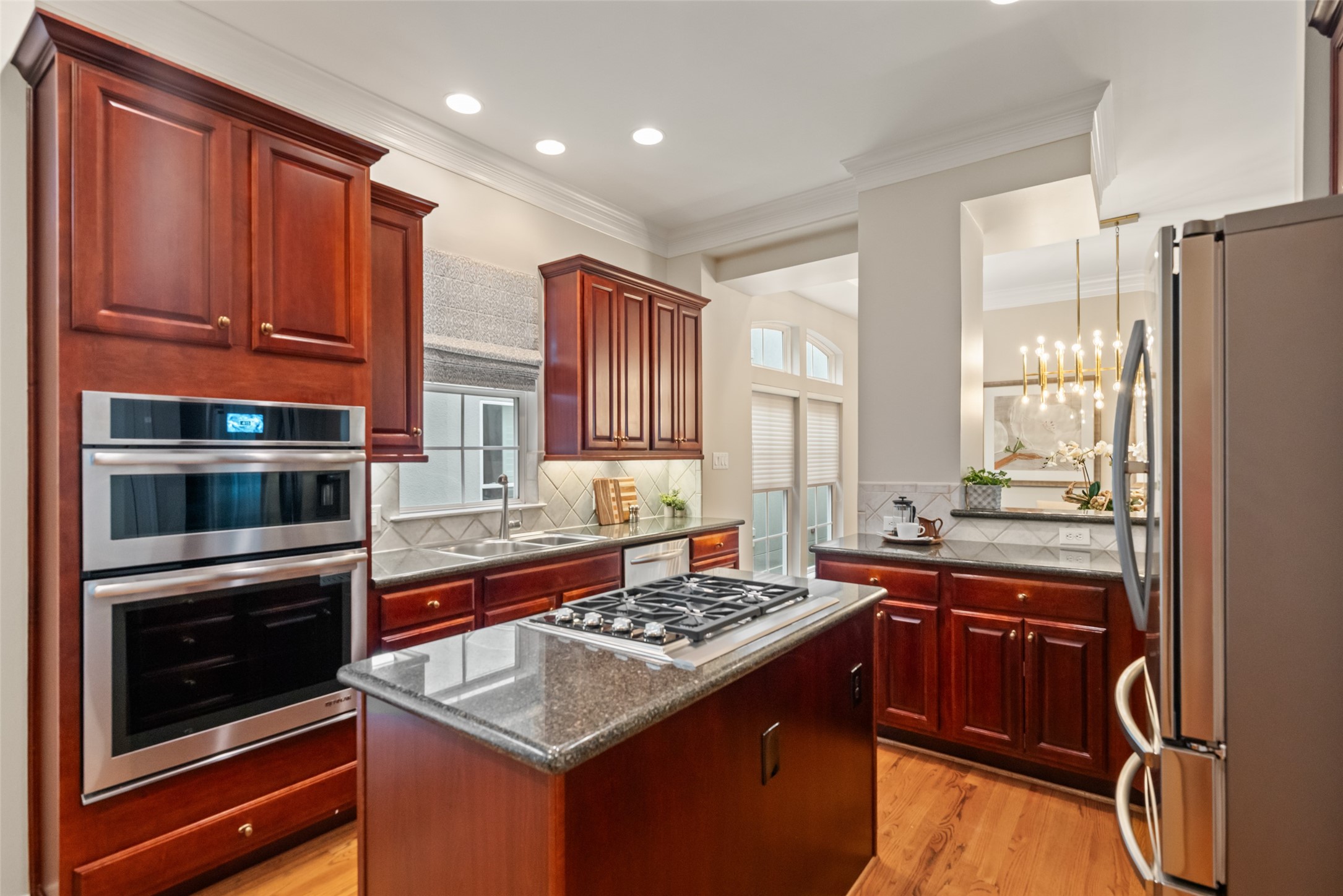 2708 Wroxton Road West University Place, TX 77005 - Photo 4 of 22 Stunning kitchen with custom cabinets, a Wolf cooktop, and a convenient wet bar with a beverage sink.