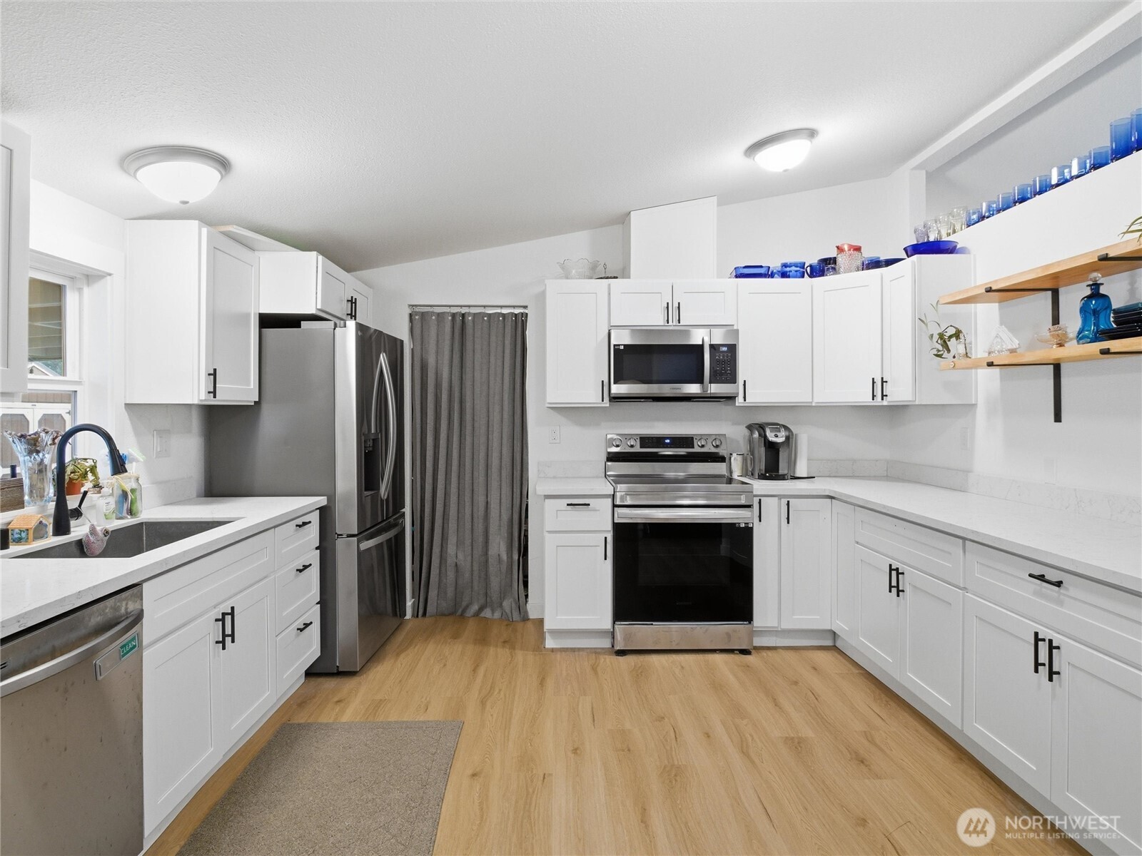 15429 107th Loop Southeast Yelm, WA 98597 - Photo 7 of 29 a kitchen with stainless steel appliances a stove sink and refrigerator