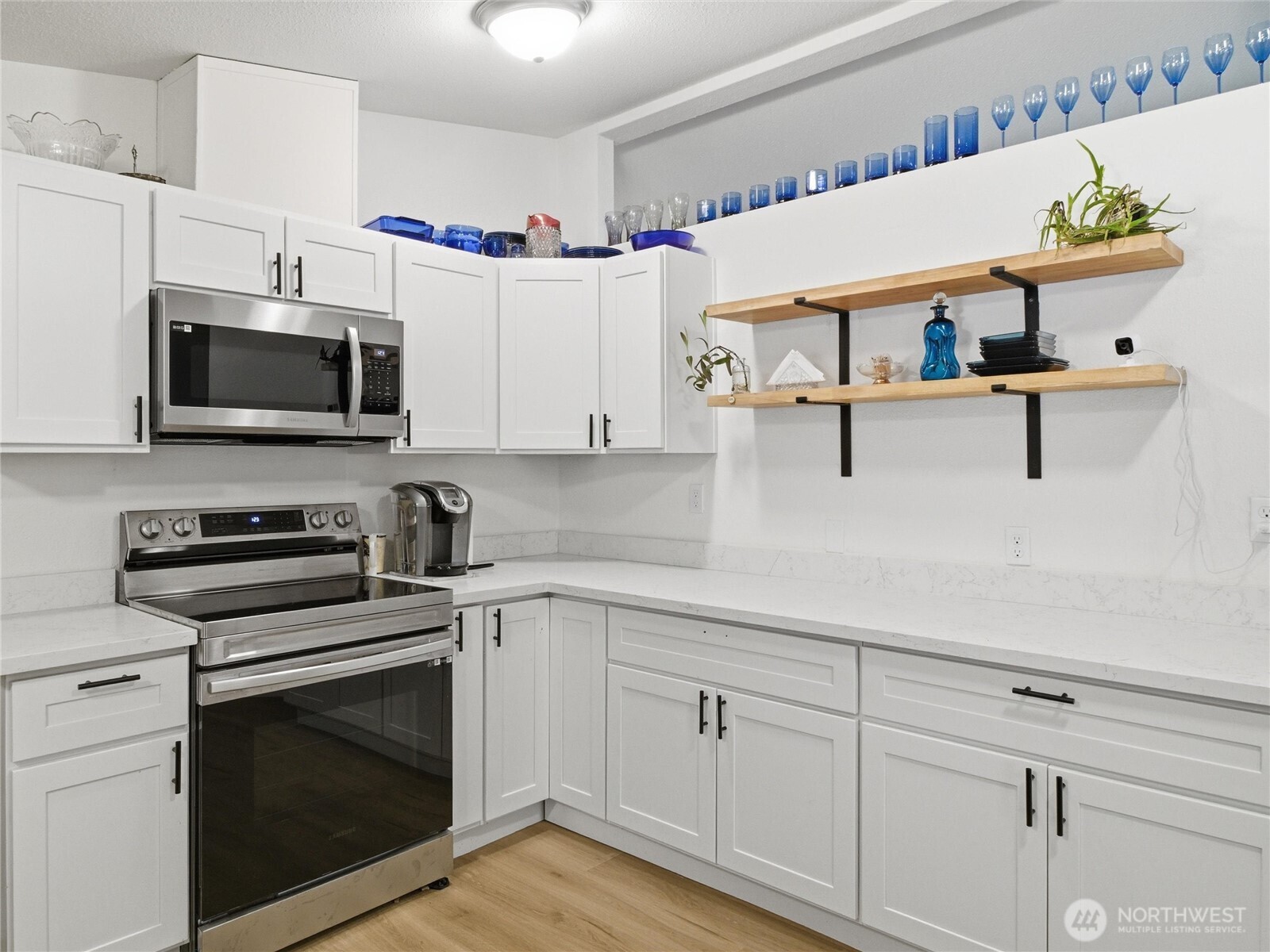 15429 107th Loop Southeast Yelm, WA 98597 - Photo 8 of 29 a kitchen with kitchen island a stove and a sink