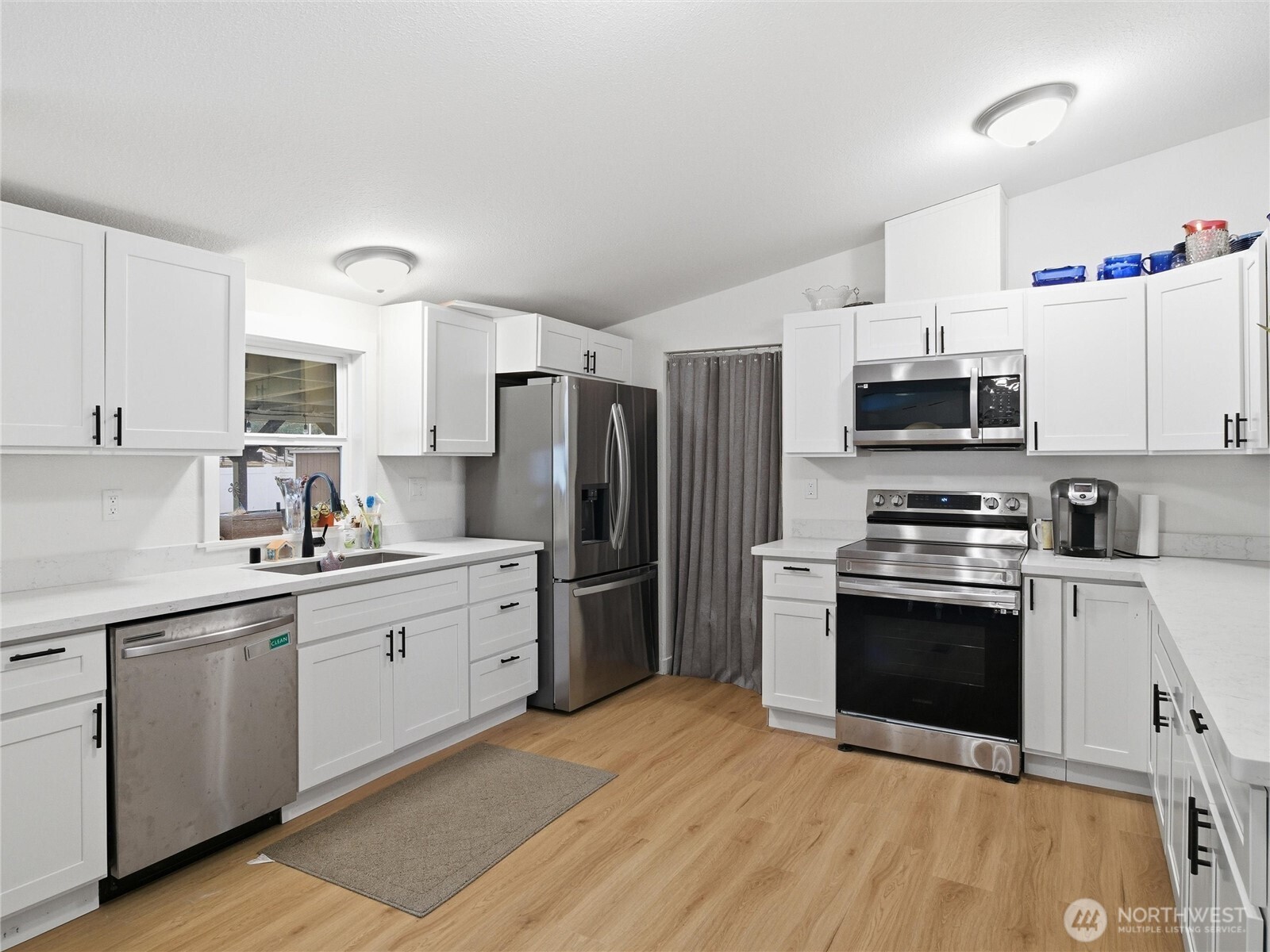 15429 107th Loop Southeast Yelm, WA 98597 - Photo 9 of 29 a kitchen with granite countertop a sink stove and refrigerator