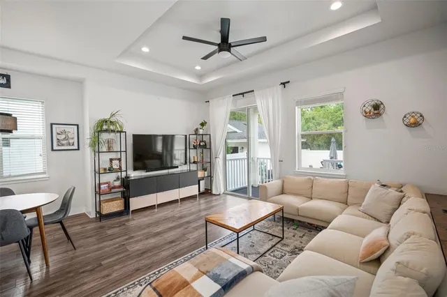 a living room with furniture a flat screen tv and a table