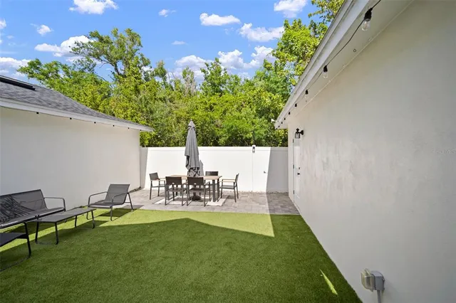 a view of yard with swimming pool and bench