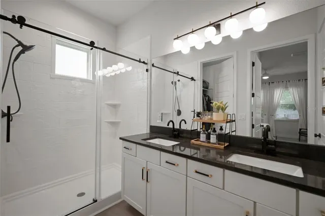 a bathroom with a double vanity sink mirror and double