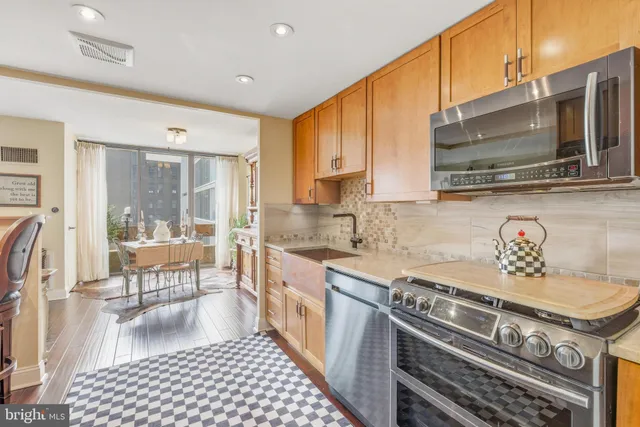 a kitchen with stainless steel appliances granite countertop a sink and a refrigerator