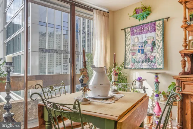 a view of a dining room with furniture one side and wooden floor