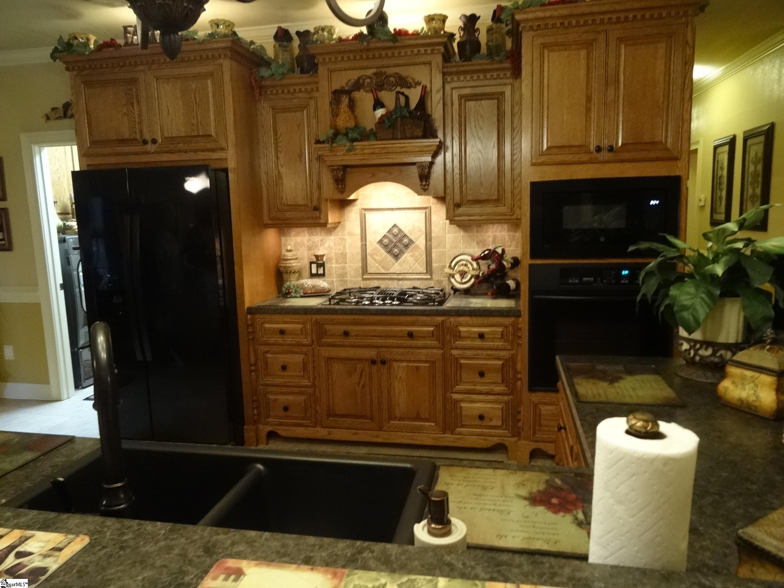 1170 Old Dacusville Road Easley, SC 29640 - Photo 8 of 35 Custom cabinetry, surface top downdraft gas range, wall oven and built-in microwave.