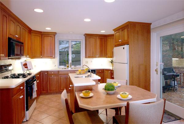 12 Meadowview Road Wayland, MA 01778 - Photo 8 of 23 a kitchen with stainless steel appliances granite countertop a stove a refrigerator a sink dishwasher a dining table and chairs with wooden floor