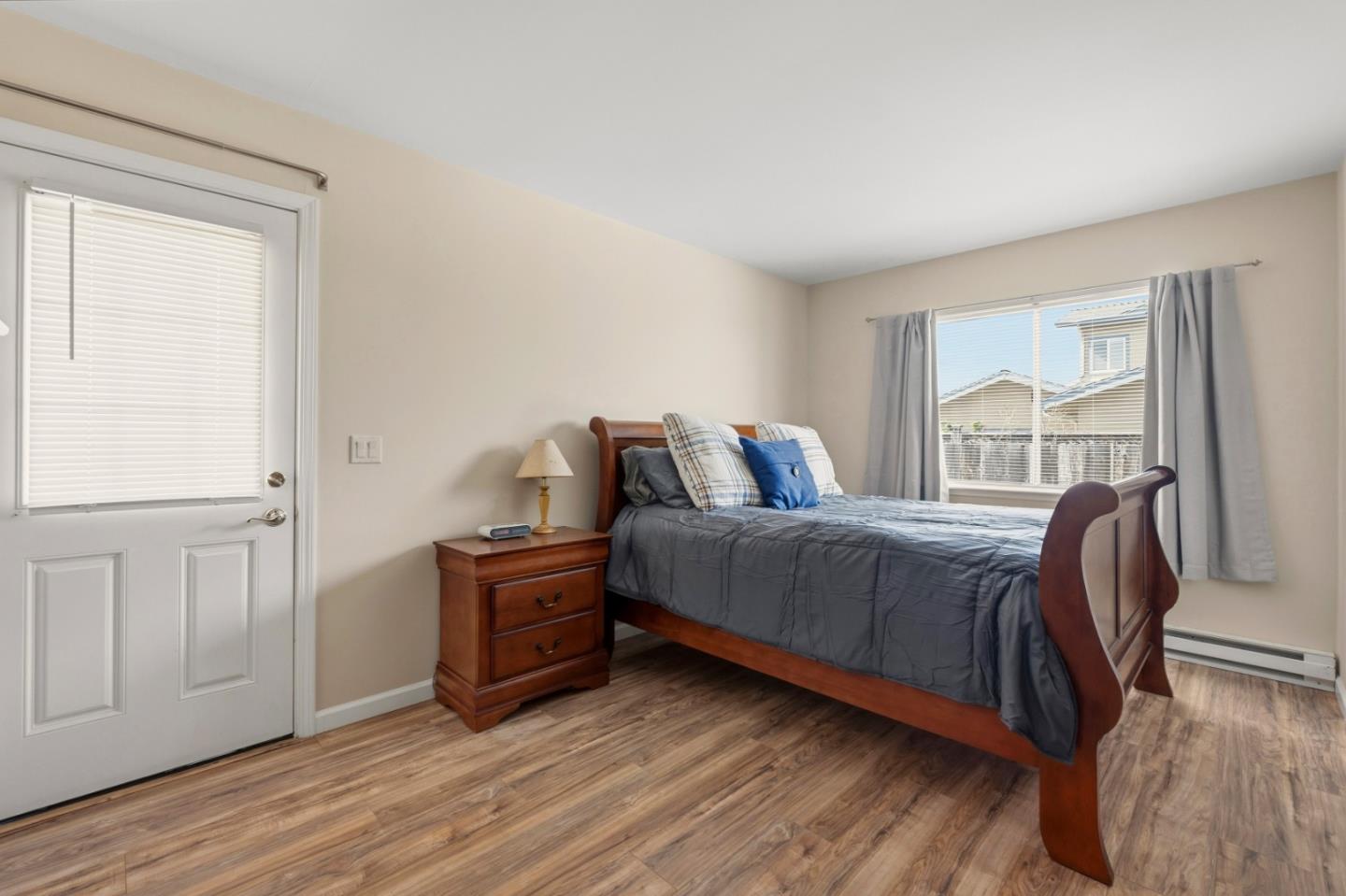 1313 Harding Street Seaside, CA 93955 - Photo 15 of 26 a bedroom with a bed and wooden floor