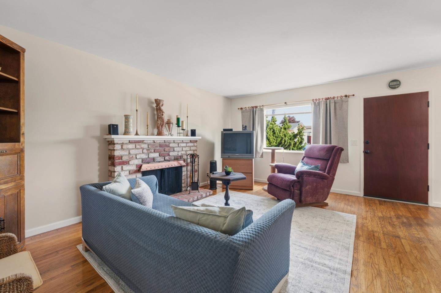 1313 Harding Street Seaside, CA 93955 - Photo 3 of 26 a living room with furniture and a fireplace