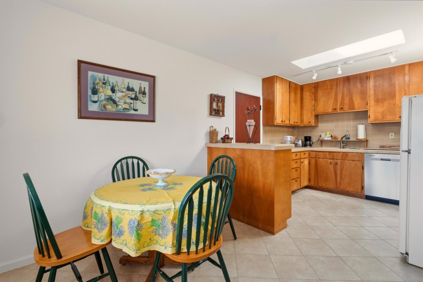 1313 Harding Street Seaside, CA 93955 - Photo 8 of 26 a kitchen with a dining table chairs and a refrigerator