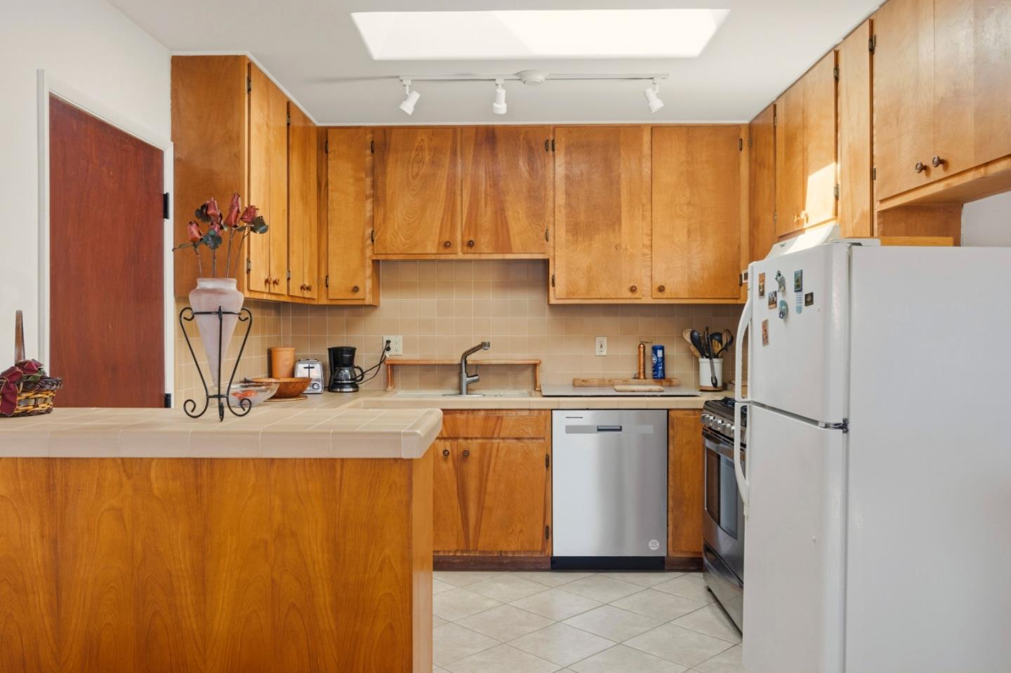 1313 Harding Street Seaside, CA 93955 - Photo 10 of 26 a kitchen with a refrigerator sink and cabinets